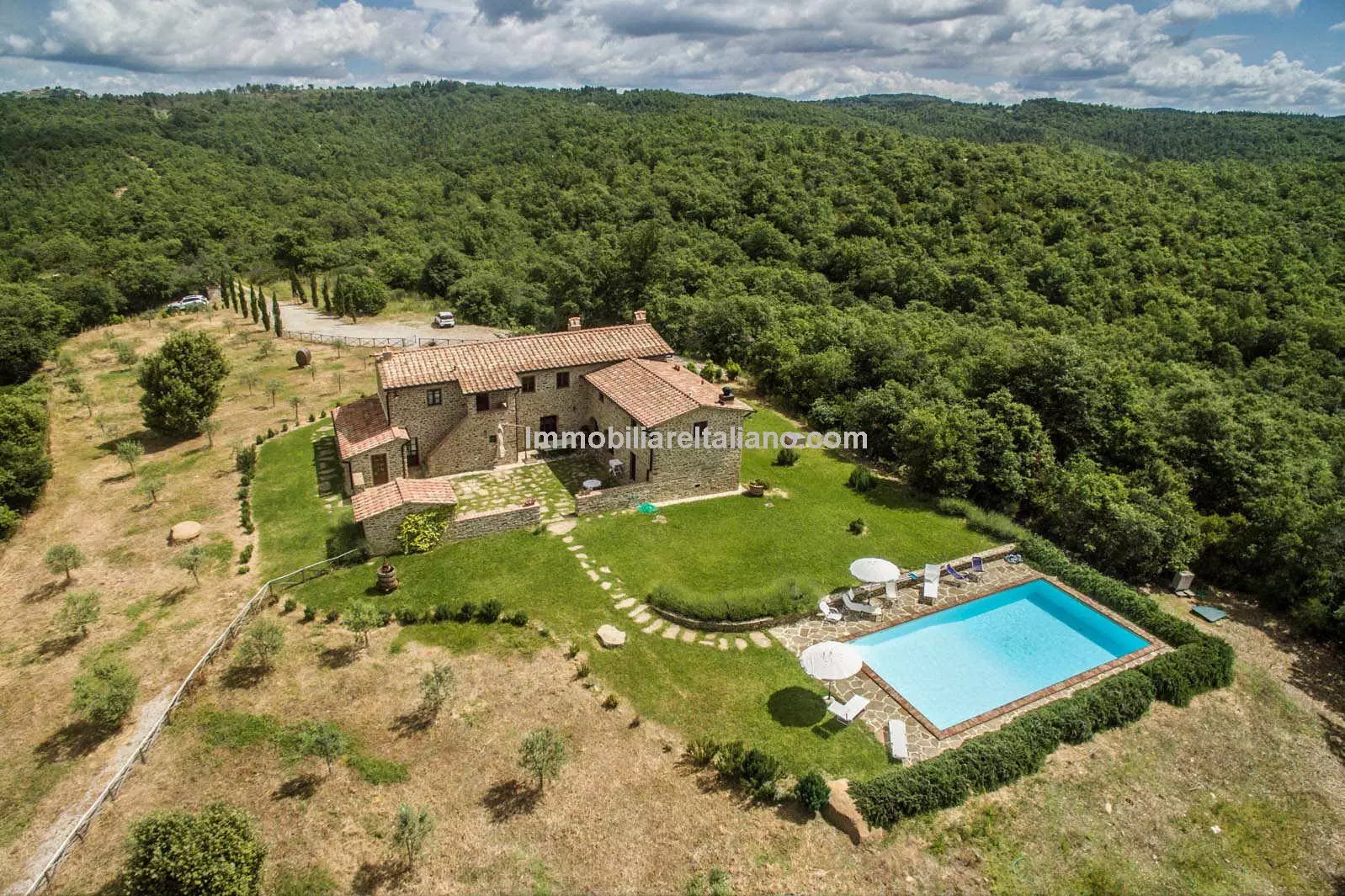 SOLDFarmhouse in Tuscany with courtyard, pool, woodland and olive grove