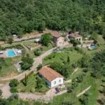 View of the buildings and a swimming pool on the Tuscan estate for sale