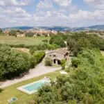 View of farmhouse and pool at boutique winery for sale Todi Umbria