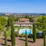 View of pool and Tuscan villa for sale