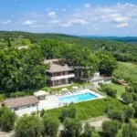 External view showing modern villa home, gardens, pool and surroundings in Tuscany