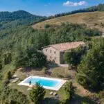 Aerial view of large farmhouse and pool in Le Marche Italy for sale