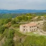 View of Montone farmhouse for sale and the Umbrian countryside surrounding it
